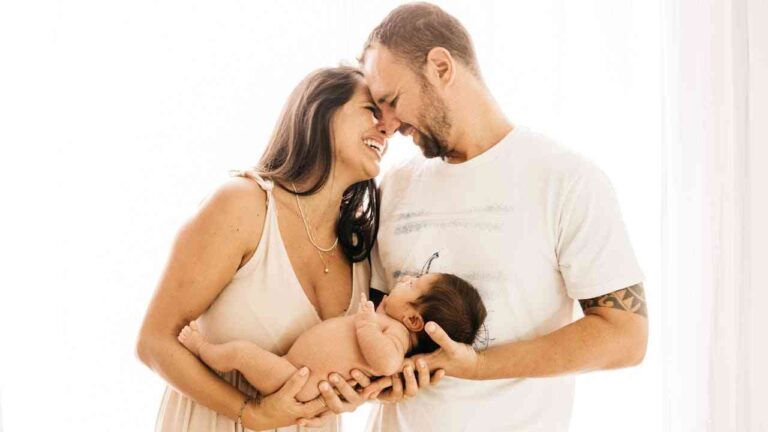Reasons to Have Children: a man and a woman hold a baby together