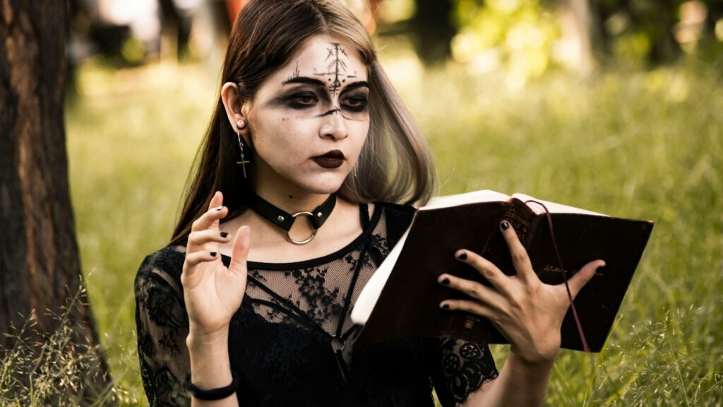 Decline of Christianity: A woman surrounded by nature with a book and tattoos on her face