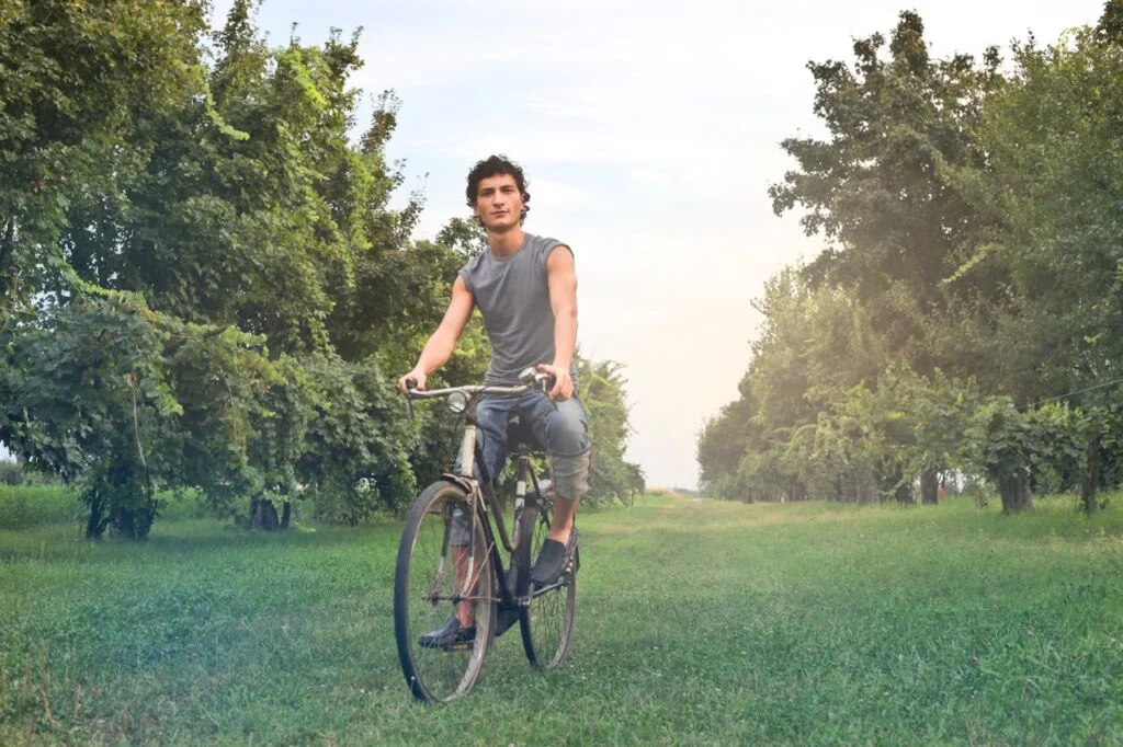 Gen Z and health: man on a bike in the orchard