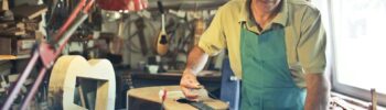 Modern craftsmanship: a craftsman in a workshop is making an acoustic guitar