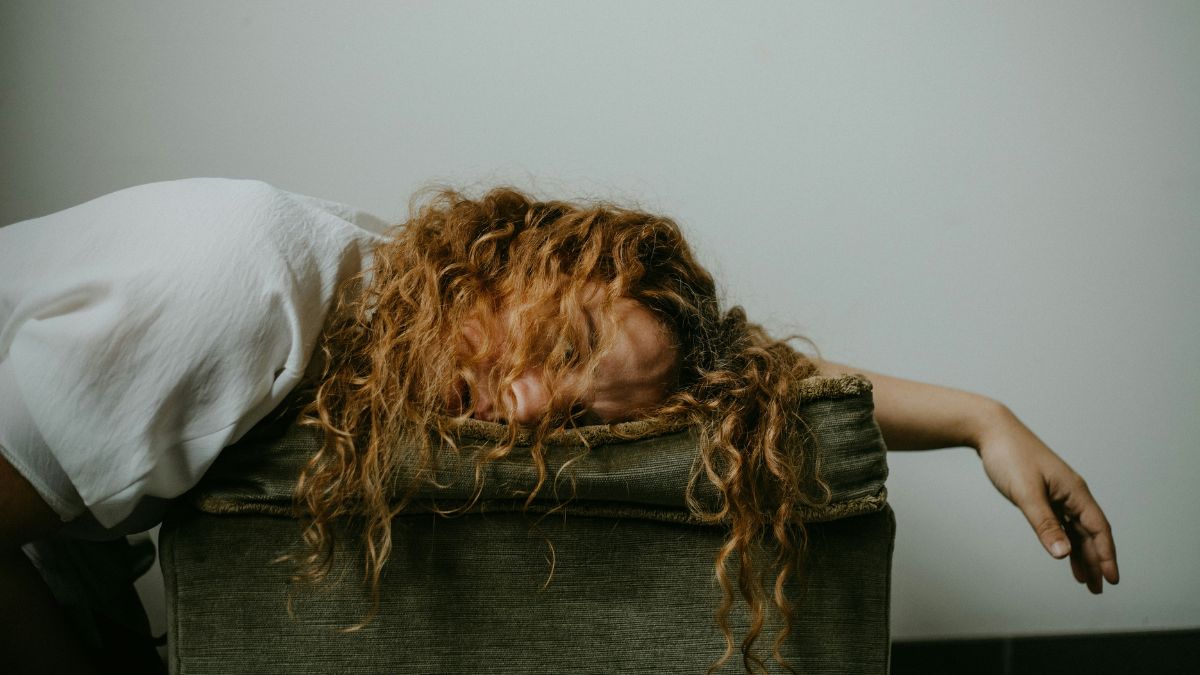 Chronic fatigue syndrome: a long-haired man lying down, exhausted.