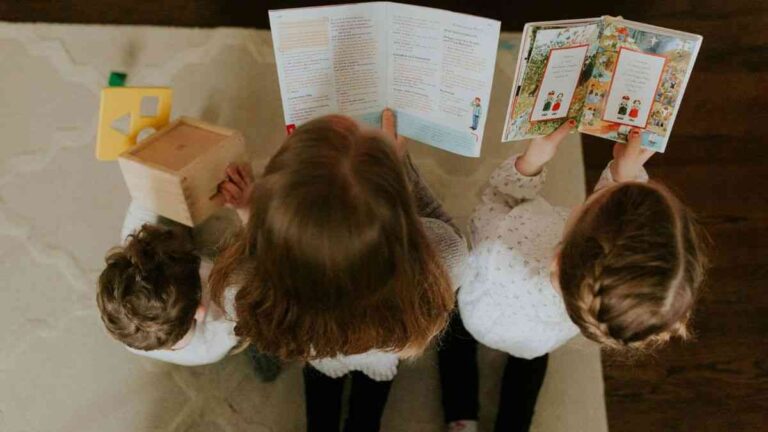 How to teach a child to read: kids with books and toys. Photo by Christi Marcheschi / Pexels.