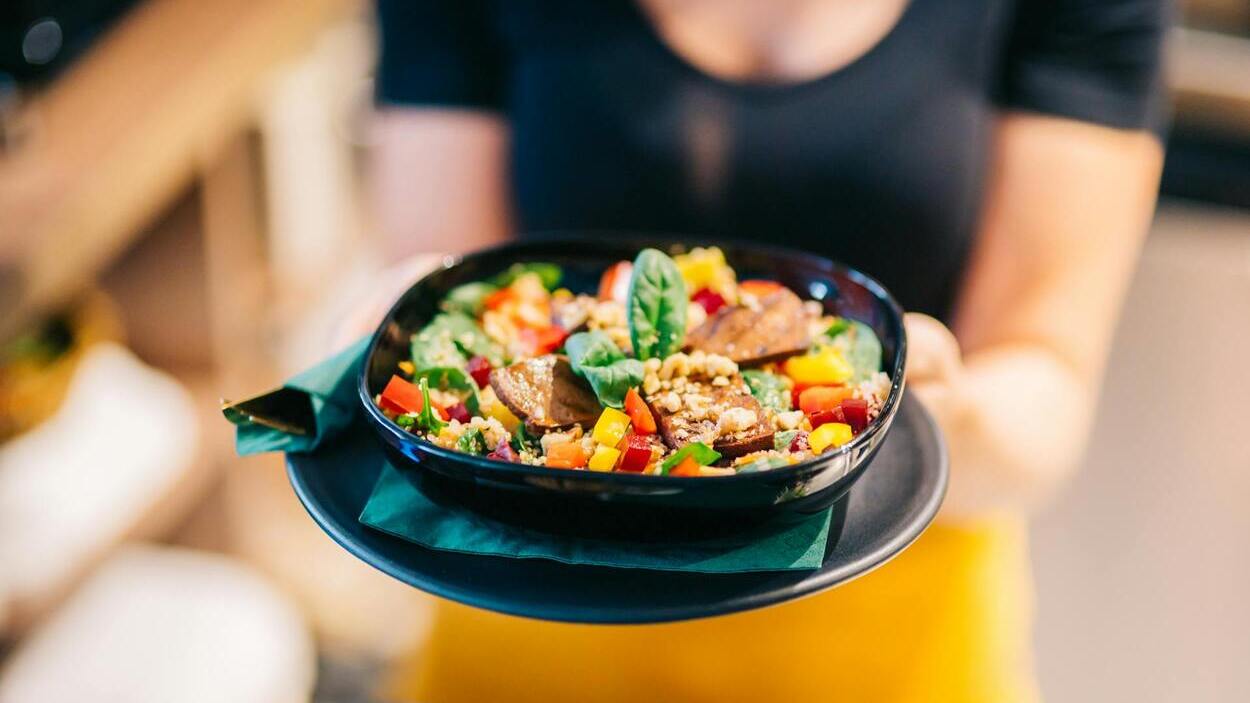 Natural Ozempic alternatives — preparing a healthy meal in the kitchen with an apple, olive oil, lentils, and GLP-1-supporting berries.