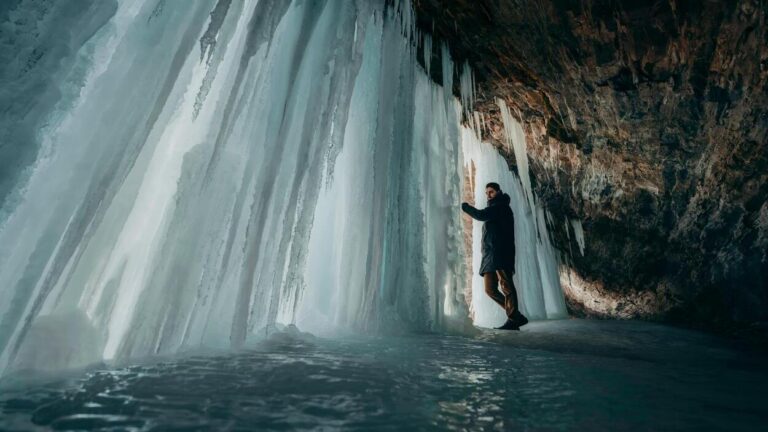 A researcher explores an ice cave where layers of permafrost have been trapped for thousands of years—similar places may conceal ancient microbes. Photo credit: Daniel Battersby/ Pexels