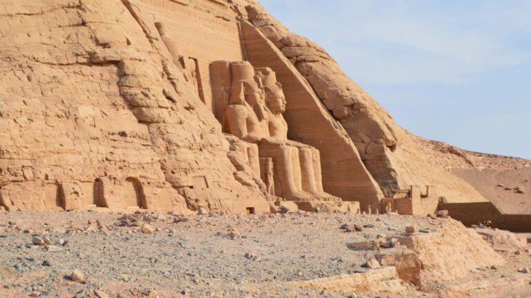 Egyptian Plague: A view of the ruins of an Egyptian temple or tomb featuring sculptures of two seated figures at the entrance.