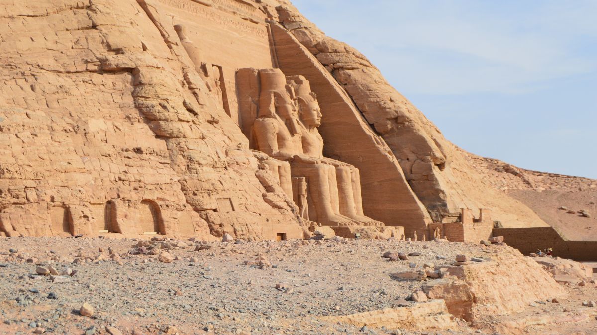 Egyptian Plague: A view of the ruins of an Egyptian temple or tomb featuring sculptures of two seated figures at the entrance.