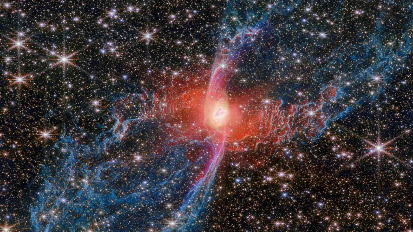 A red object against a dark sky filled with stars.