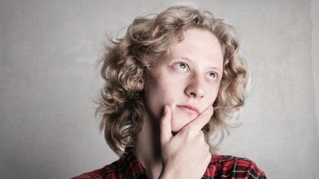 The structure of the world: a thoughtful young person with a hand on their chin — reflecting on the ancient Greek arche.