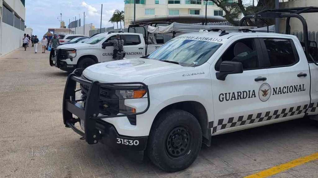 A National Guard patrol moves through a Mexican tourist resort—heavily armed officers guard the streets of a nation gripped by the power of Mexican drug cartels and the vast reach of the country's narco-business.