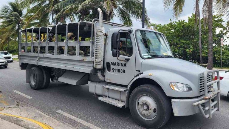 Armed Mexican navy soldiers patrol a street in a tourist resort — a show of state strength in a country scarred by the drug trade in Mexico.