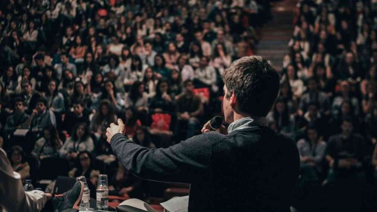 A lecturer speaking to an audience at a conference — a debate on how political correctness affects science.