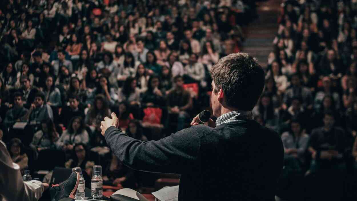 A lecturer speaking to an audience at a conference — a debate on how political correctness affects science.