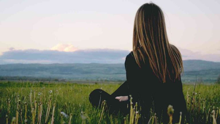 A young woman gazing at the landscape alone