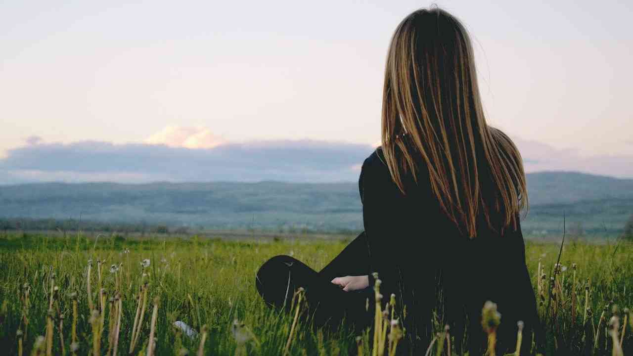 A young woman gazing at the landscape alone
