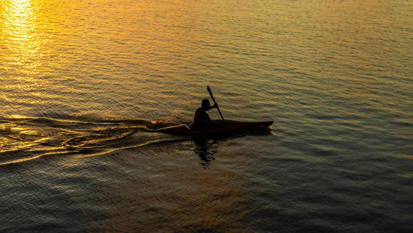 A man in a kayak on the ocean may discover how to find meaning in life.