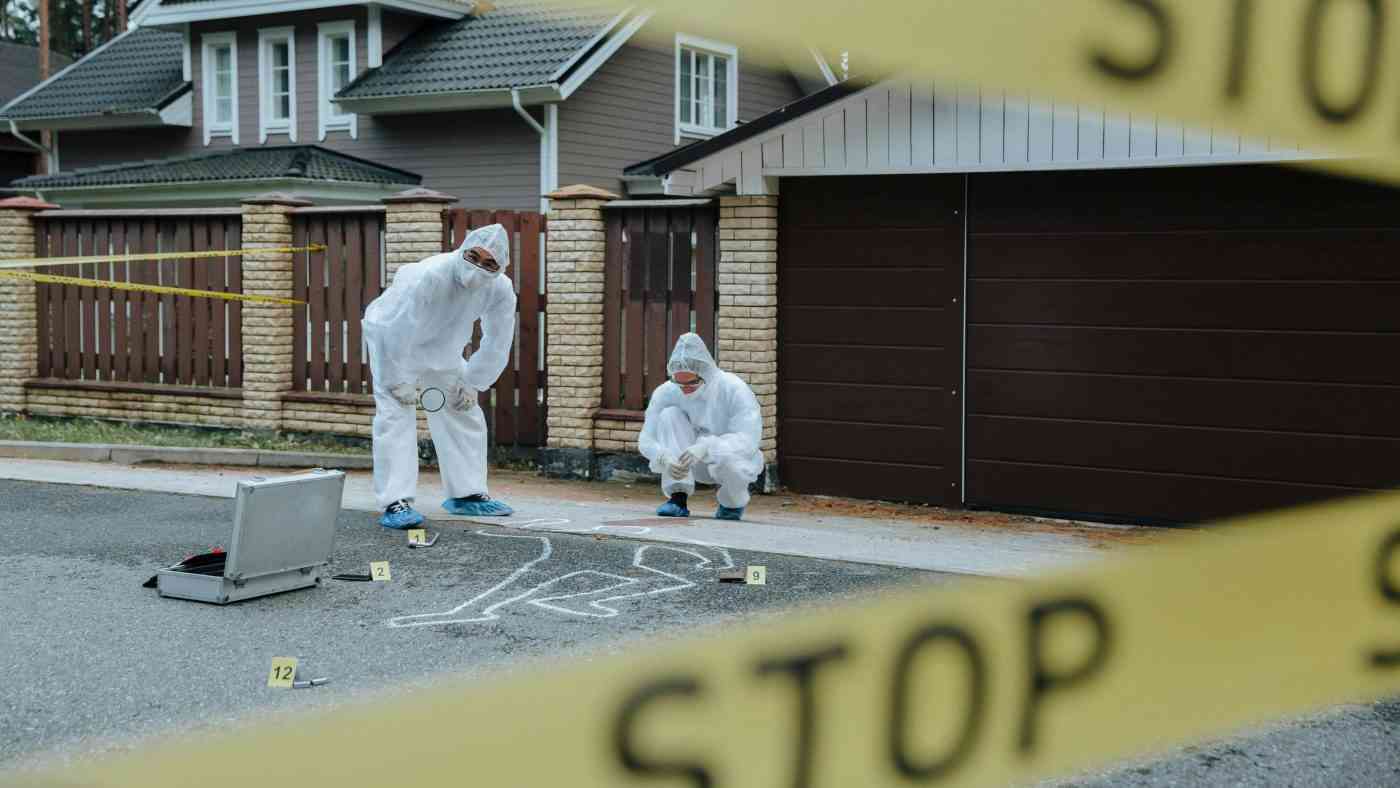Forensic technicians at a crime scene, true crime podcasts are taking over pop culture