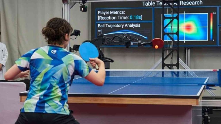 The photo shows a woman playing table tennis with a robot. It depicts a robot-versus-human contest.