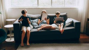 Children sitting on a sofa and staring at computer screens — is AI raising children?