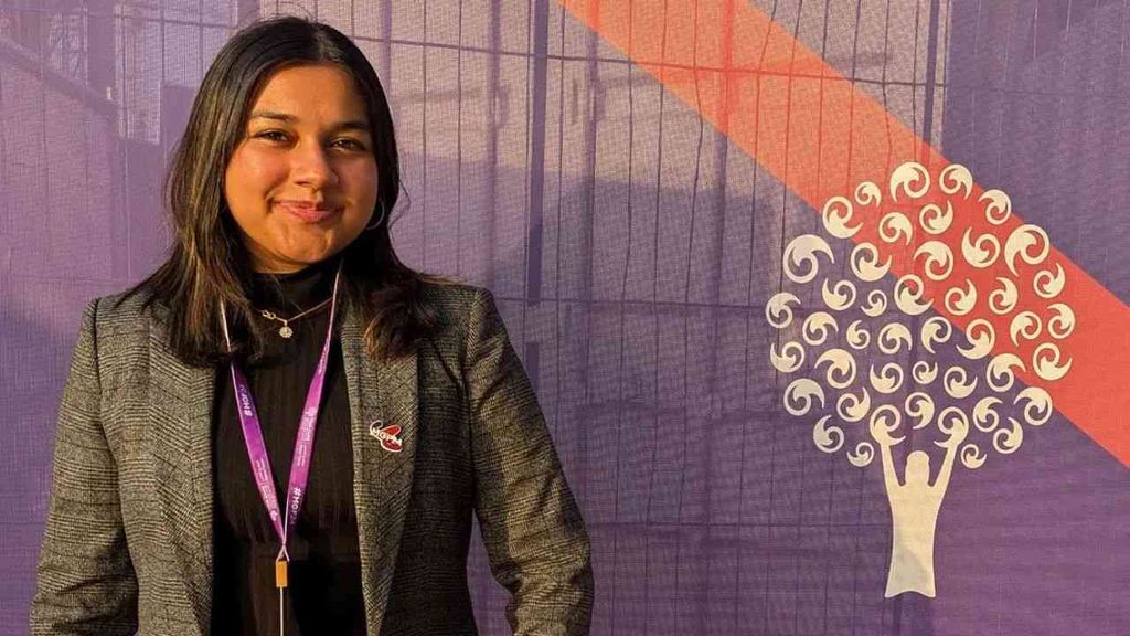 Gitanjali Rao in a medium close-up against a purple background.