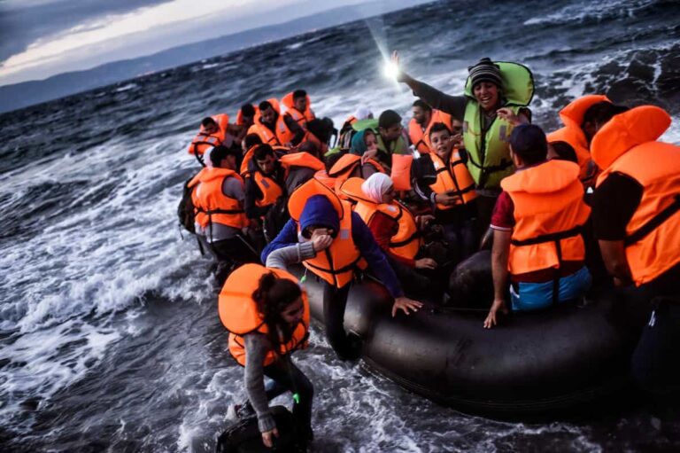 TOPSHOTS Refugees and migrants arrive at the Greek island of Lesbos after crossing the Aegean sea from Turkey on October 1