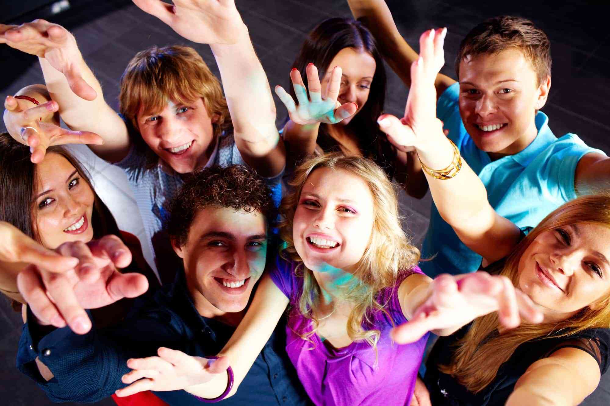 Photo of smiling friends dancing during the party