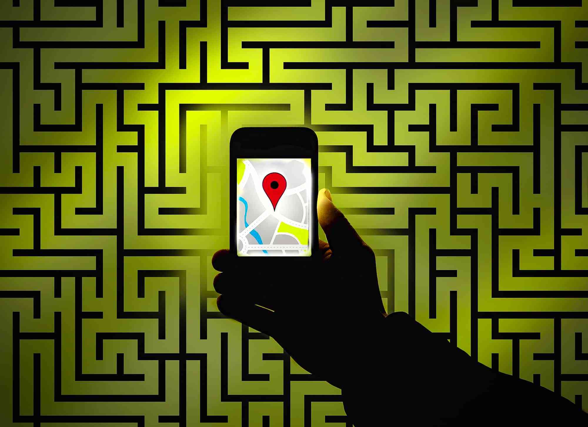 Hand using sat nav to find way in maze