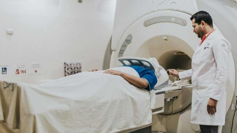 Starzenie się mózgu: Pacjent przygotowywany do badania rezonansem magnetycznym mózgu pod nadzorem lekarza.